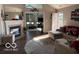 Comfortable living room with fireplace, hardwood floors, and an open floor plan at 11503 Winding Wood Dr, Indianapolis, IN 46235