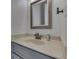 A well-lit bathroom featuring a stone countertop, a mirror, and a white background at 3270 Cherokee Cir, Bargersville, IN 46106