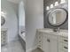 Bright bathroom with double vanity, white cabinets, a tub and an archway at 3270 Cherokee Cir, Bargersville, IN 46106