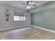 Bedroom featuring modern laminate flooring and a bright window illuminating the room at 3270 Cherokee Cir, Bargersville, IN 46106