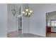 Open dining room featuring elegant chandelier, hardwood floors and archway entrance at 3270 Cherokee Cir, Bargersville, IN 46106