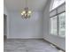 Bright dining room boasts hardwood floors, large window, and decorative chandelier at 3270 Cherokee Cir, Bargersville, IN 46106