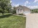 Long driveway and two-car garage offer ample parking and storage in a landscaped setting at 3270 Cherokee Cir, Bargersville, IN 46106