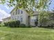 Well-manicured lawn and landscaping surround this home with large windows, creating an inviting outdoor space at 3270 Cherokee Cir, Bargersville, IN 46106