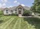 An inviting front exterior of a beautiful house boasts a well-manicured lawn and elegant architectural details at 3270 Cherokee Cir, Bargersville, IN 46106