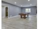 Spacious basement game room with wood-look flooring, offering ample space for entertainment at 3270 Cherokee Cir, Bargersville, IN 46106