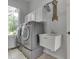 Well-lit laundry room features a modern washer and dryer and convenient sink at 3270 Cherokee Cir, Bargersville, IN 46106
