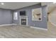 Basement living room featuring a gray color scheme, fireplace and wood-look floors at 3270 Cherokee Cir, Bargersville, IN 46106