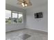 Simple room with tile floors, a fan, and a blank TV on the wall at 3270 Cherokee Cir, Bargersville, IN 46106