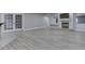 Open living area with modern flooring, fireplace, and glass doors at 3270 Cherokee Cir, Bargersville, IN 46106
