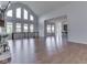 Spacious living room with gleaming hardwood floors, tall windows, and an open layout at 3270 Cherokee Cir, Bargersville, IN 46106