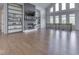 Bright living room featuring custom built-ins, a cozy fireplace, and abundant natural light, creating an inviting atmosphere at 3270 Cherokee Cir, Bargersville, IN 46106