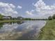 Scenic community pond with lush greenery enhances the neighborhood's natural beauty at 3270 Cherokee Cir, Bargersville, IN 46106