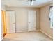 Carpeted bedroom with natural light, ceiling fan, and neutral paint at 3400 W Riggin Rd, Muncie, IN 47304