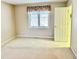 Bright bedroom with neutral walls, window, and access to adjacent rooms at 3400 W Riggin Rd, Muncie, IN 47304