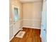 Home entryway featuring hardwood floors, decorative rug, and half wall molding at 3400 W Riggin Rd, Muncie, IN 47304