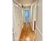 Hallway with laminate floors connects to multiple rooms in the house at 3400 W Riggin Rd, Muncie, IN 47304