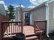 Back deck of home with stained wood railings and a grated door to the back entrance at 5332 Fletcher Ave, Indianapolis, IN 46219