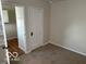 Neutral bedroom with carpet flooring, closet, and open door to a connected room at 5332 Fletcher Ave, Indianapolis, IN 46219