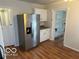 Bright kitchen featuring stainless steel refrigerator, wood floors, and ample storage space at 5332 Fletcher Ave, Indianapolis, IN 46219