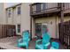 Enjoy the back deck with blue Adirondack chairs, grill, and sliding door entrance at 5370 Bay Harbor Dr, Indianapolis, IN 46254