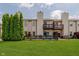 The townhome boasts a fenced-in backyard with lush grass, landscaping, and a wood deck at 5370 Bay Harbor Dr, Indianapolis, IN 46254
