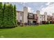 The townhome boasts a fenced-in backyard with lush grass, landscaping, and a wood deck at 5370 Bay Harbor Dr, Indianapolis, IN 46254