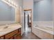 Bathroom featuring a soaking tub, vanity with generous counter space, and neutral finishes at 5370 Bay Harbor Dr, Indianapolis, IN 46254