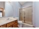 Bathroom featuring a walk-in shower with glass doors, single sink vanity, and tile flooring at 5370 Bay Harbor Dr, Indianapolis, IN 46254