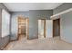 Bedroom with neutral carpet, a large window and multiple walk-in closets at 5370 Bay Harbor Dr, Indianapolis, IN 46254