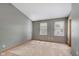 Bedroom featuring neutral carpeting, two windows with blinds, and neutral paint at 5370 Bay Harbor Dr, Indianapolis, IN 46254