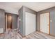 Hallway showing laminate flooring, gray walls, access to a bathroom, and a large closet at 5370 Bay Harbor Dr, Indianapolis, IN 46254