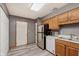 The kitchen is equipped with wooden cabinets, modern appliances, and laminate floors at 5370 Bay Harbor Dr, Indianapolis, IN 46254
