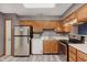 The kitchen boasts wooden cabinets, laminate flooring, and stainless steel appliances at 5370 Bay Harbor Dr, Indianapolis, IN 46254