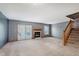 Spacious living room with a fireplace, plush carpet and sliding glass doors to the outside at 5370 Bay Harbor Dr, Indianapolis, IN 46254