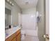 Well-lit bathroom featuring a single sink vanity and a shower-tub combination at 5548 Glen Canyon Dr, Indianapolis, IN 46237