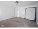 Bedroom with neutral carpet, a door, and a mattress leaning against the wall at 5548 Glen Canyon Dr, Indianapolis, IN 46237