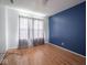 Bedroom with hardwood floors, large window, and soft gray curtains, offering style and comfort at 5548 Glen Canyon Dr, Indianapolis, IN 46237
