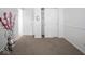 Spacious bedroom with white trim, neutral carpet, and dual closets for ample storage at 5548 Glen Canyon Dr, Indianapolis, IN 46237