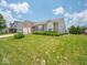 Lovely brick home with an attached garage, complemented by a well-kept lawn and colorful flowerbeds at 5548 Glen Canyon Dr, Indianapolis, IN 46237