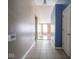 Hallway featuring tile flooring and neutral wall paint leading to a living space with hardwood floors at 5548 Glen Canyon Dr, Indianapolis, IN 46237