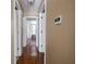 Hallway featuring hardwood floors and white doors leading to bedrooms and living spaces at 5548 Glen Canyon Dr, Indianapolis, IN 46237