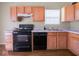 Kitchen showcasing black appliances and wooden cabinets at 5548 Glen Canyon Dr, Indianapolis, IN 46237