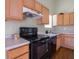 Kitchen with wooden cabinetry and black appliances at 5548 Glen Canyon Dr, Indianapolis, IN 46237