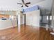 Open-concept living room with hardwood floors, partial wall dividing the kitchen, and a view to tiled entryway at 5548 Glen Canyon Dr, Indianapolis, IN 46237