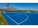 Outdoor basketball court with blue playing surface and clear markings, adjacent to community amenities and green spaces at 6253 Wasco Dr, Whitestown, IN 46075