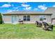 Relaxing backyard with well-kept lawn, patio seating, and a grill at 6383 Enclave Blvd, Greenwood, IN 46143