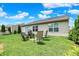 Spacious backyard with chairs, landscaping and manicured green grass at 6383 Enclave Blvd, Greenwood, IN 46143