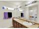 Bright bathroom featuring a double vanity with two sinks and a large mirror with lights at 6383 Enclave Blvd, Greenwood, IN 46143