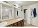 Bright bathroom with a large mirror, a sink and a shower with glass doors at 6383 Enclave Blvd, Greenwood, IN 46143